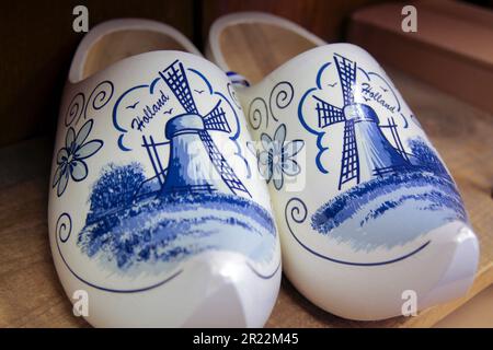 Holland Dutch Wooden Clogs Klompen. White with delft blue painting of windmill scene. Stock Photo