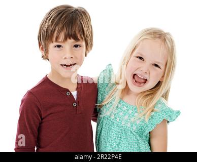 Who needs imaginary friends when weve got each other. Studio shot of a cute little boy and girl posing together against a white background. Stock Photo