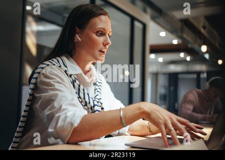 Female freelancer having a discussion on a video call. Professional woman having an online meeting with her clients. business woman doing remote work Stock Photo