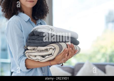 Clean laundry, holding and hands with towels from the wash for the house and fresh linen. Cleaner, organize and a woman with clothes in an apartment Stock Photo