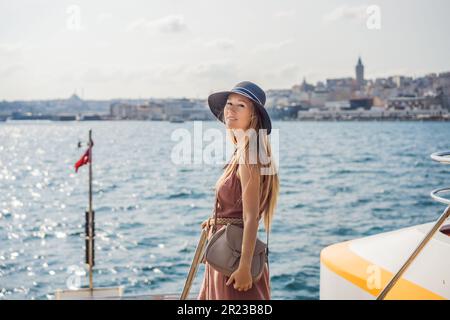 Portrait of beautiful woman tourist with view of Galata tower in Beyoglu, Istanbul, Turkey. Turkiye Stock Photo