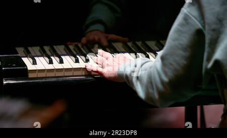 The image of the left hand on playing the piano keys Stock Photo