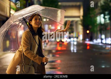 Japanese woman in the rain Stock Photo