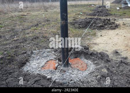 Fence post installation. Fence footings. Close up on concrete footing ...