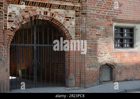Old gate in  a old building from red bricks. Stock Photo