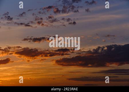 Clouds on a blue sky background during sunset Stock Photo