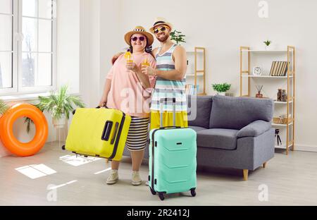 Happy family couple enjoying summer vacation, going on trip, and drinking cocktails Stock Photo