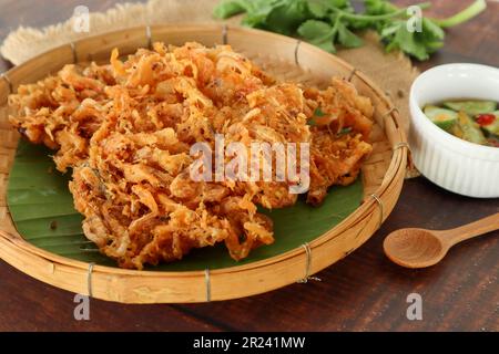 Shrimp fritters, deep fried small shrimp served cucumber dipping sauce at close up view - Thai street food called Koong  Tord Stock Photo