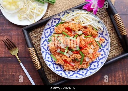 Mee Krob - Thai appetizer of  Mixed Crispy Rice Noodle served in bamboo tray at top view,  Authentic Thai food Stock Photo