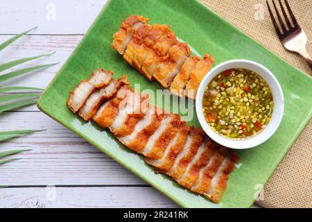 Deep fried pork belly with spicy sauce  - In Thai called Moo Tord at top view Stock Photo