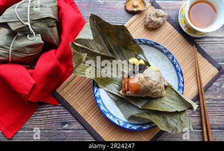 Zongzi - Chinese rice dumpling for Dragon boat festival at top view on wood table Stock Photo