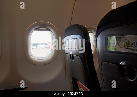 row of seats in easyjet aircraft looking out at george best belfast city airport belfast northern ireland uk Stock Photo