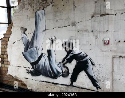 Non Exclusive: BORODIANKA, UKRAINE - MAY 16, 2023 - The mural by British artist Banksy that features a boy defeating an adult man in judo sparring is Stock Photo