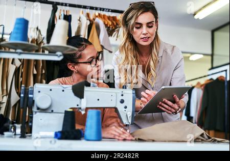 This is the technique I want you to follow. two fashion designers working together in a workshop. Stock Photo