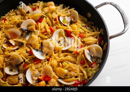 Fideua paella with shellfish, monkfish and clams. Traditional Spanish recipe. Stock Photo