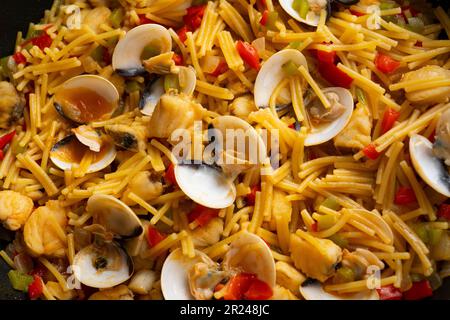 Fideua paella with shellfish, monkfish and clams. Traditional Spanish recipe. Stock Photo
