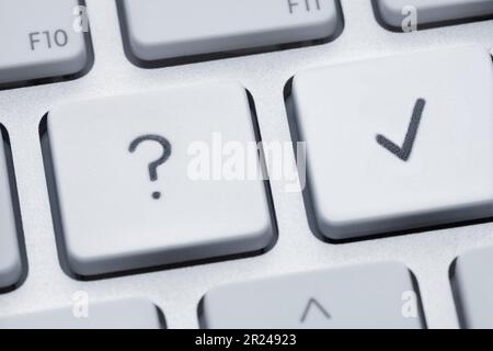 Closeup view and shallow focus against two keys on keyboard showing doubt sign and checking option Stock Photo