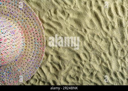 An white straw hat lies on a rock on the beach Stock Photo - Alamy