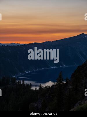 Afterglow of Sunset Reflects in Clouds Over Crater Lake National Park Stock Photo