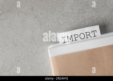Note with word Import in documentation on light grey table, top view. Space for text Stock Photo