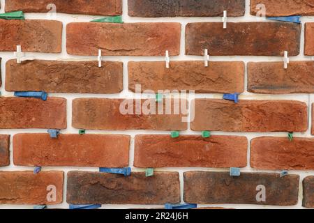 Decorative bricks with tile leveling system on wall Stock Photo