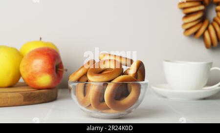 Bowl with delicious ring shaped Sushki (dry bagels) on white table Stock Photo
