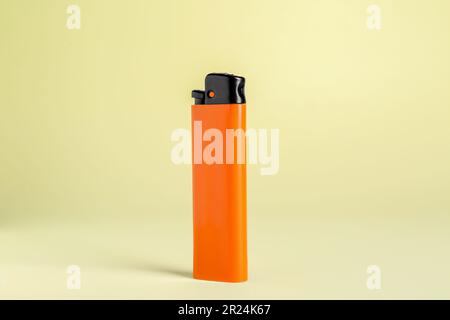 Stylish small pocket lighter on beige background Stock Photo
