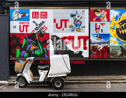 tokyo, harajuku - may 10 2023: Japanese Honda Gyro three-wheeled motorcycle illegally parked in front of a wall with advertise posters featuring japan Stock Photo
