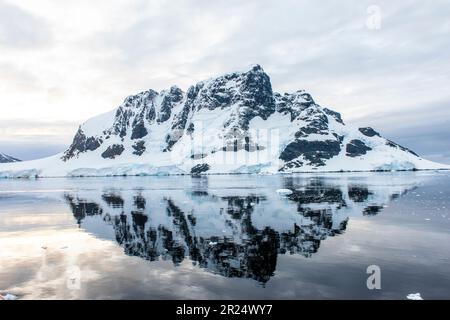 Lemaire Channel, Antarctica. Quiet reflection of a mountain on the Lemaire Channel. Stock Photo