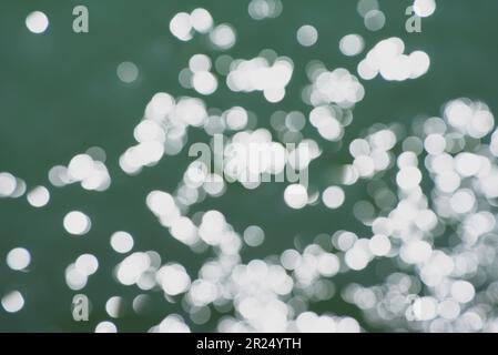 Sun glare oval circles on sea waves on sunny day. Stock Photo