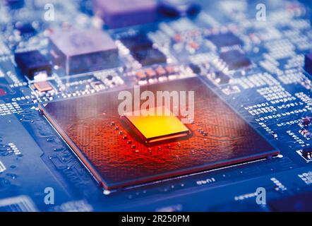 The computer processor CPU overheating and smokes around on computer motherboard, blue logic board with microprocessor. Stock Photo