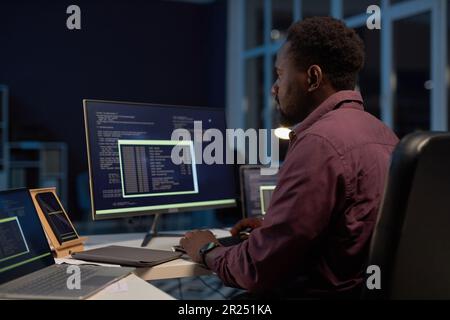 African American developer concentrating on development of software on computer Stock Photo
