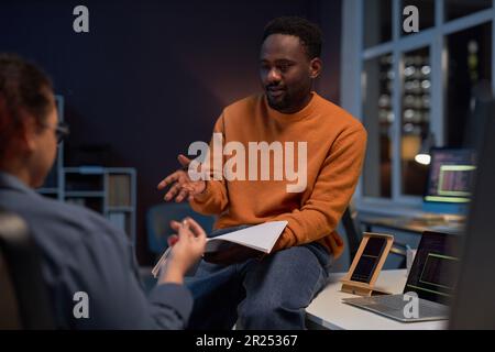 Couple of programmers working over new project in office till late night Stock Photo