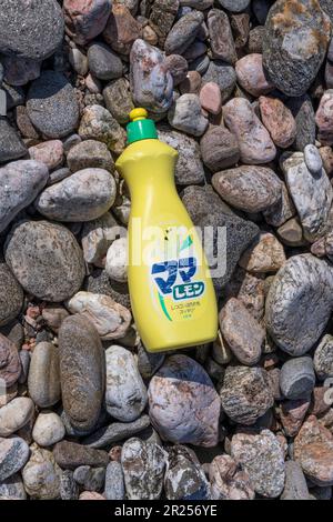 A plastic bottle of detergent made by the Japanese company  Lion Corporation.  Washed up on a Shetland beach. Stock Photo