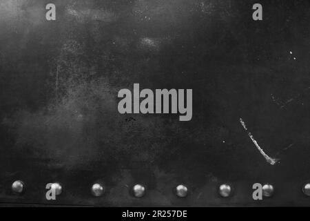 Scratched textured surface of leather material with metal rivets. Overlay for your design with space to copy. High quality photo Stock Photo