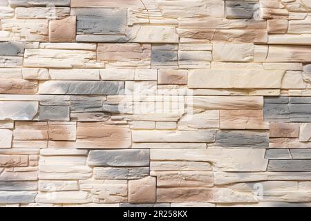 ingots, bars, blocks, brick of white beige grey brown decorative stones, tiles lay one on another, in appropriate manner, modern interior, facade Stock Photo