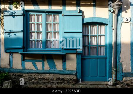 Gerberoy is ont of the most beautiful village of France - Man walking in the street - Blue Shutters | Gerberoy avec ses rues pavees typiques, ses toit Stock Photo