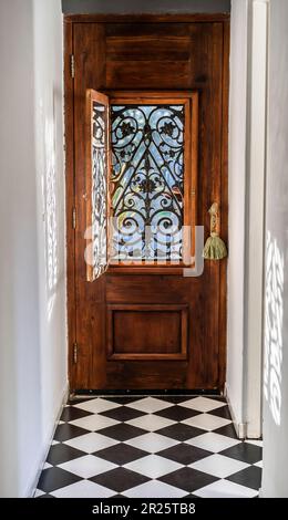 Trendy wooden front door from the inside house. Stock Photo