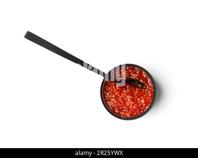 Red salmon caviar in a black tin can and in a black decorative spoon on a white background. Useful delicacy seafood, canned fish. Stock Photo