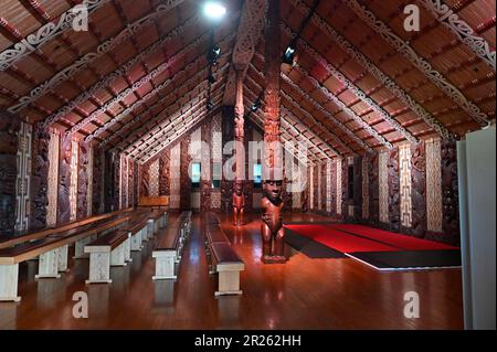 The ceremonial house at Waitangi is called the Whare Rūnanga. It is a significant structure located within the Waitangi Treaty Grounds in New Zealand. The Whare Rūnanga serves as a symbol of partnership and unity between Māori and the British Crown.  The Whare Rūnanga is a traditional Māori meeting house built in the style of a carved wharenui (large house). It was constructed in 1940 to commemorate the centenary of the signing of the Treaty of Waitangi Stock Photo