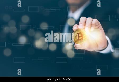 Businessman Hand holding Bitcoin New virtual money coin over us dollars close up, Digital Money and Bitcoin Concept. Cryptocurrency golden coin, stock Stock Photo