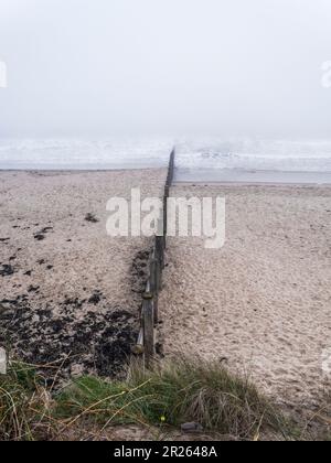 Wooden groynes to prevent sand drift and erosion at Blyth beach, Northumberland, UK Stock Photo