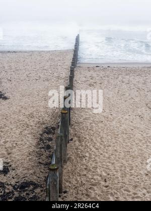 Wooden groynes to prevent sand drift and erosion at Blyth beach, Northumberland, UK Stock Photo