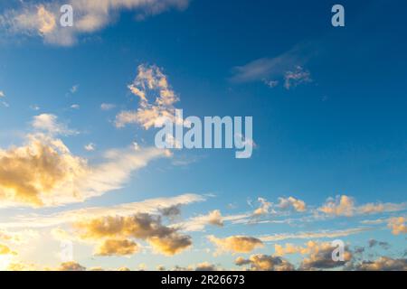 big sheep clouds are illuminated by sun from below - Altocumulus Stock Photo