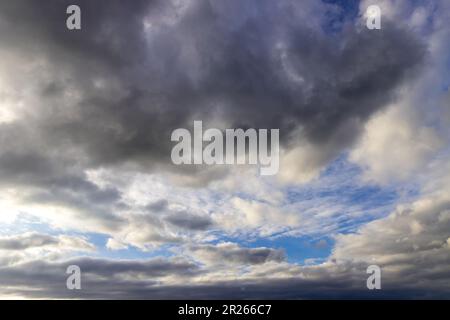 dark rain clouds broken by the sun - Stratocumulus Stock Photo
