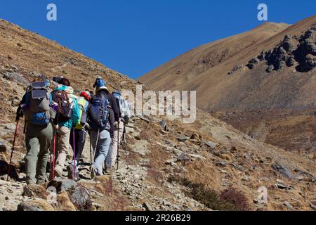 Trekkers walking in the mountains in Bhutan Stock Photo
