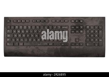 front view closeup of old black keyboard with keys covered in dust and dirt isolated on white background Stock Photo