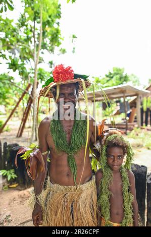 Grandfather and grandaughter dressed up in traditional indigenous clothing Stock Photo