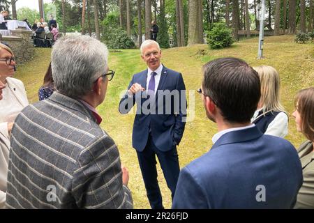 Riga, Latvia. 17th May, 2023. Krisjanis Karins (M), Prime Minister of Latvia, talking with other former graduates of the Latvian High School in Münster. Credit: Alexander Welscher/dpa/Alamy Live News Stock Photo