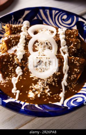 Enchiladas de Mole. Also known as mole poblano enchiladas, they are a typical Mexican dish that is very popular in Mexico and the rest of the world. Stock Photo